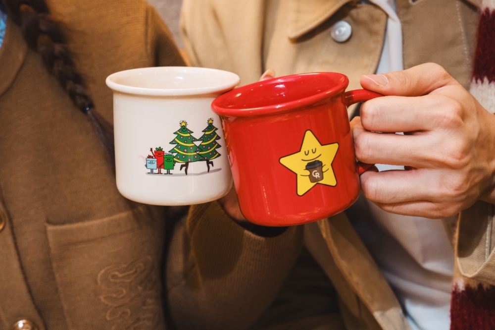 A pair of hands holding two mugs AI-generated content may be incorrect.