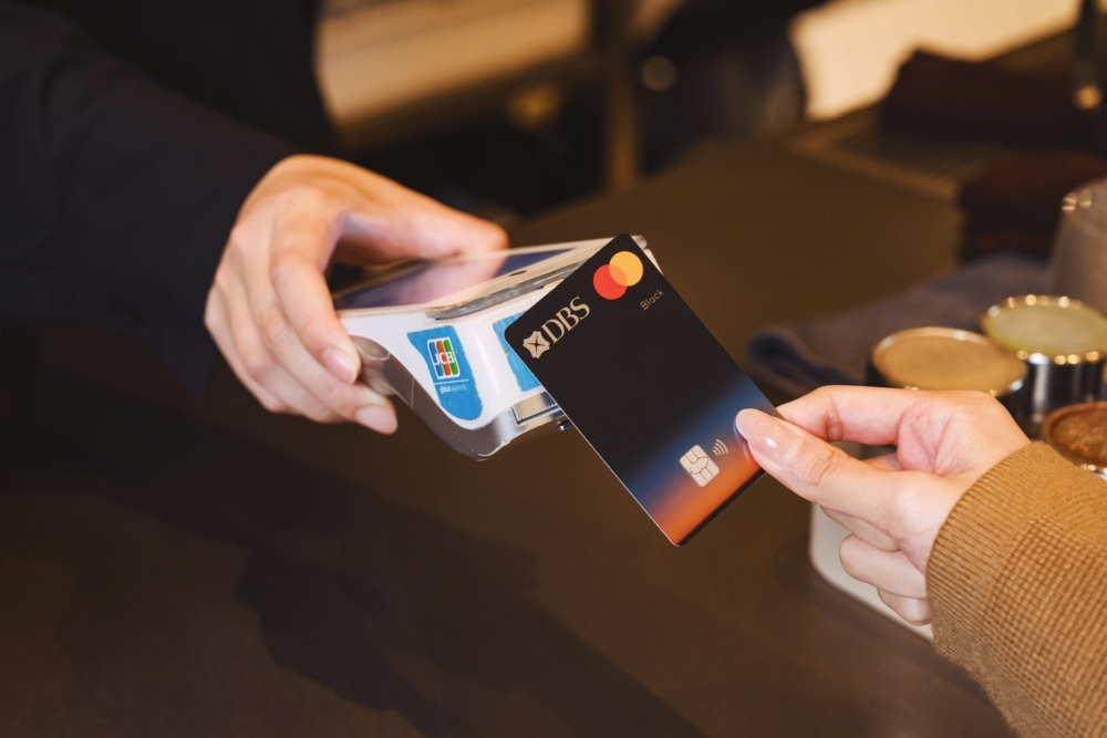 A person paying with a credit card AI-generated content may be incorrect.