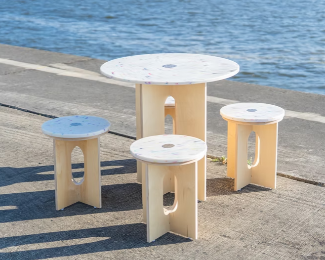 A table and stools on a dock
AI-generated content may be incorrect.