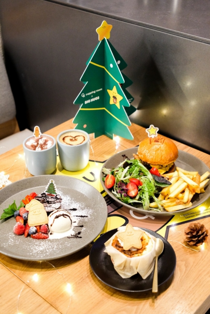 A table with plates of food and a christmas tree AI-generated content may be incorrect.