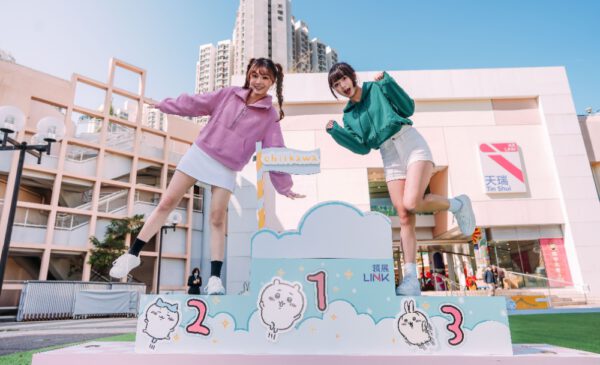 Two women jumping on a podium Description automatically generated