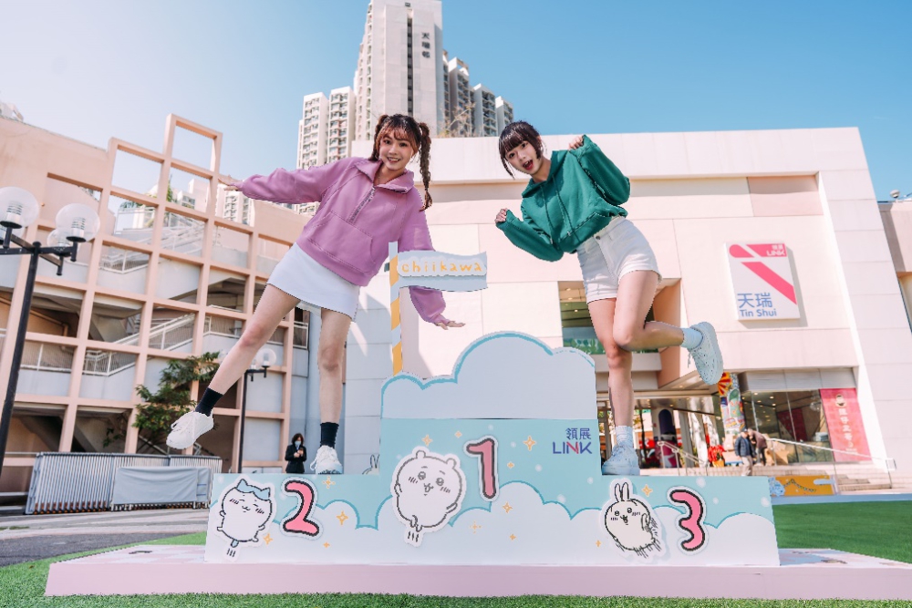 Two women jumping on a podium

Description automatically generated