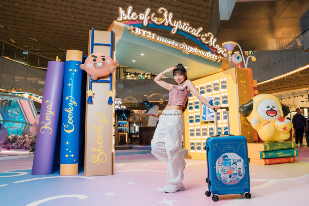 A person posing with luggage
Description automatically generated