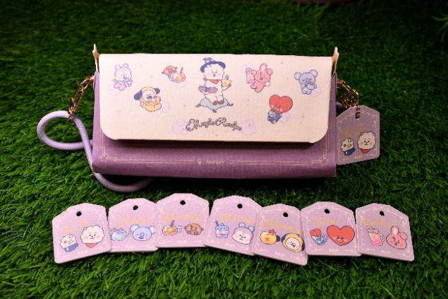A purple purse with tags on it

Description automatically generated