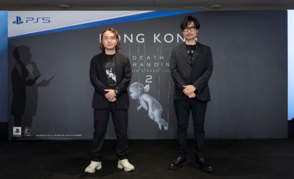 Two men standing in front of a wall AI-generated content may be incorrect.